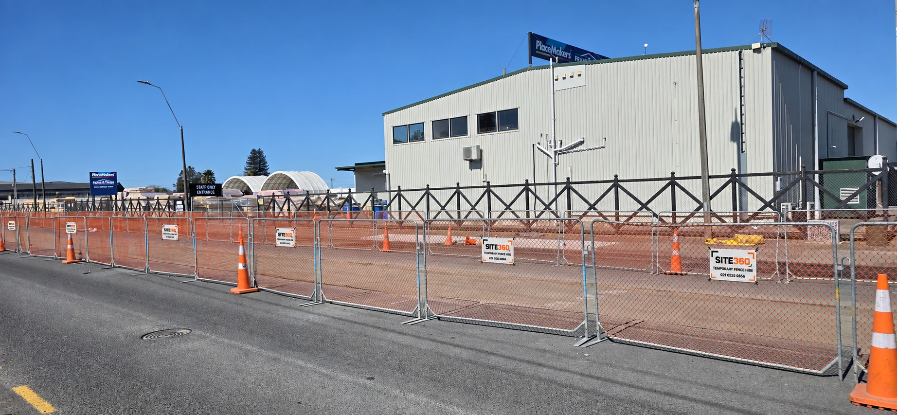 Hi-vis orange construction barriers installed along a Hastings work site