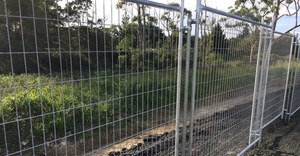 Galvanised temporary security fence panels installed on site