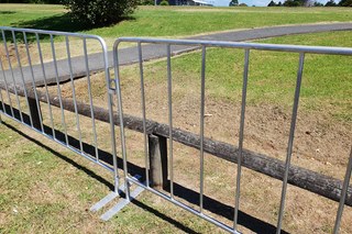 Row of galvanised crowd control barriers
